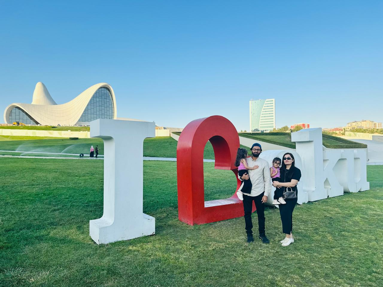 Alqama Faisal and her family visiting the I Love Baku sign in Azerbaijan on August 2026