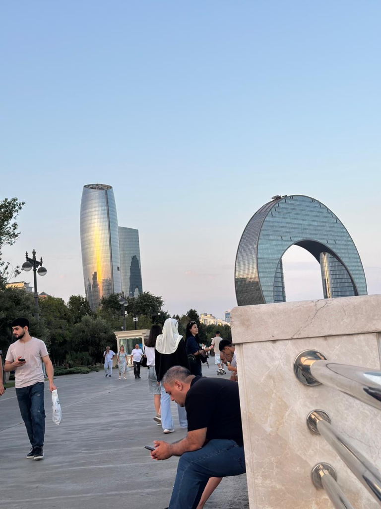 Baku Boulevard promenade with modern Baku skyline and waterfront views at sunset