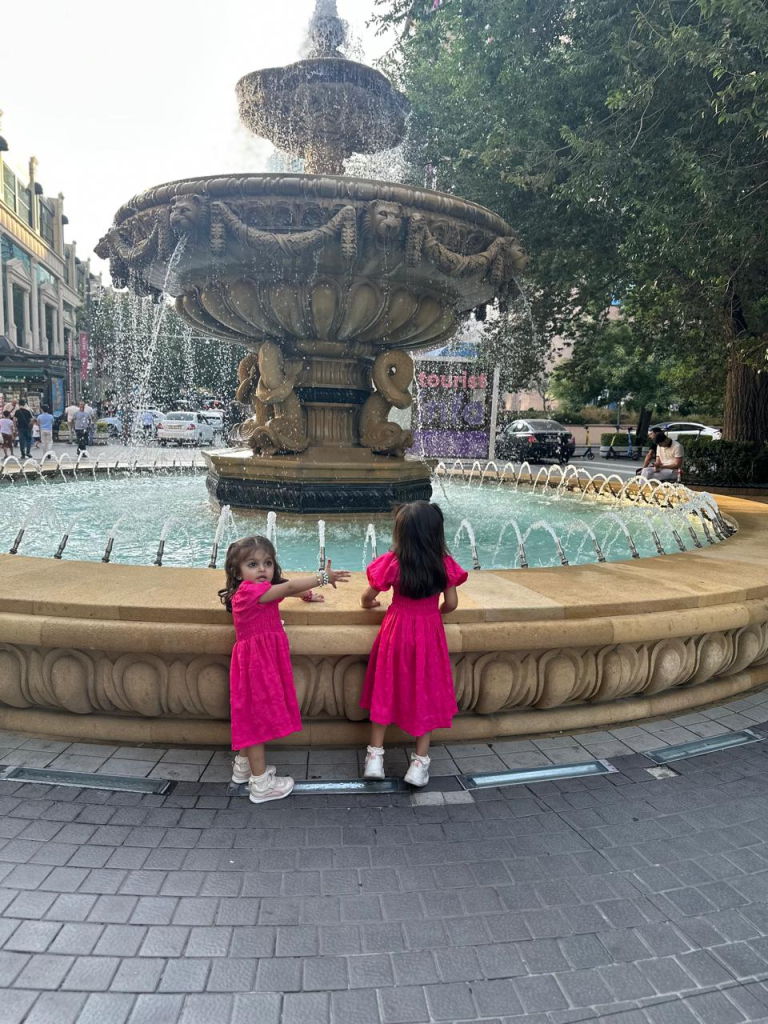 Fatima and Zainab enjoying a fountain on Nizami Street in Baku