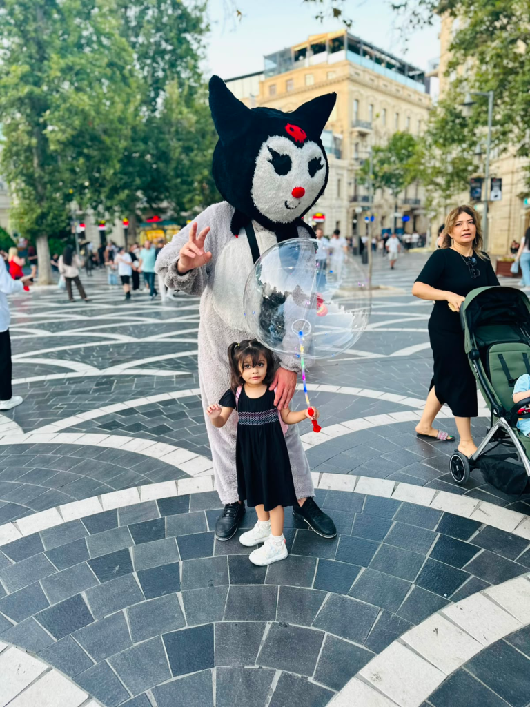Fatima posing with a cat mascot on Nizami Street in Baku