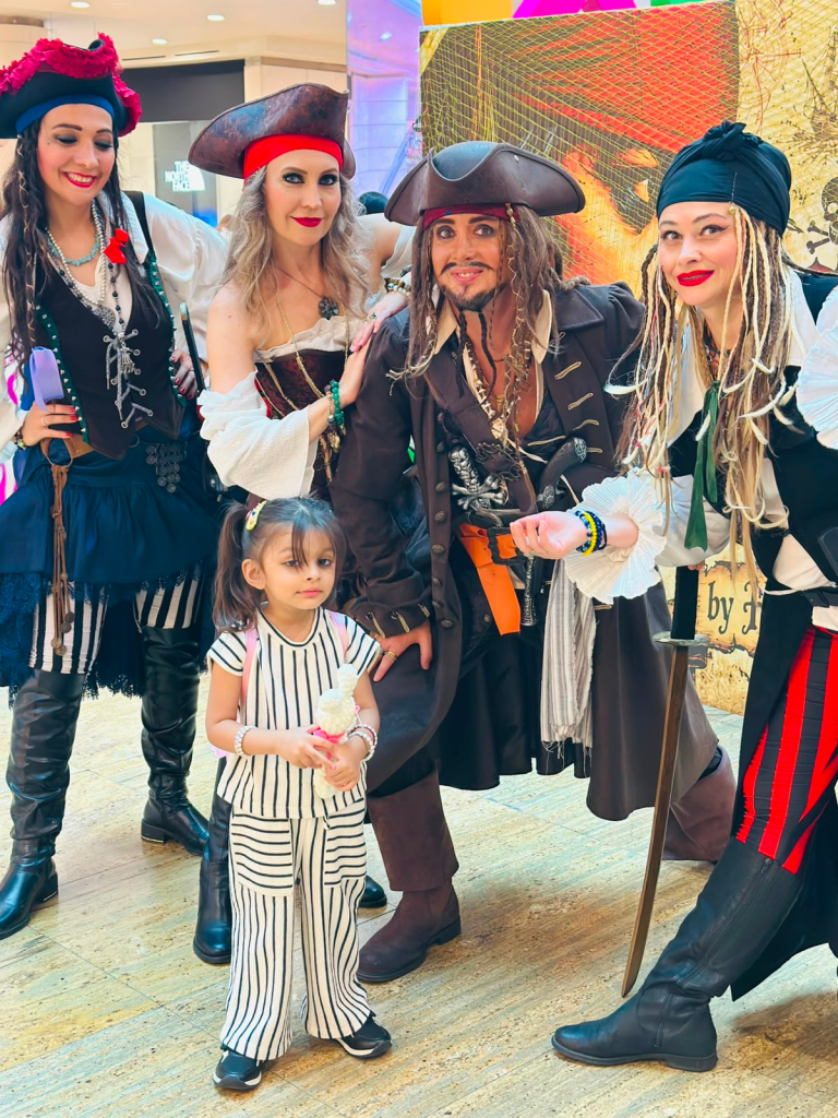 Fatima posing with pirate-themed performers during a family visit to a shopping mall in Baku, Azerbaijan