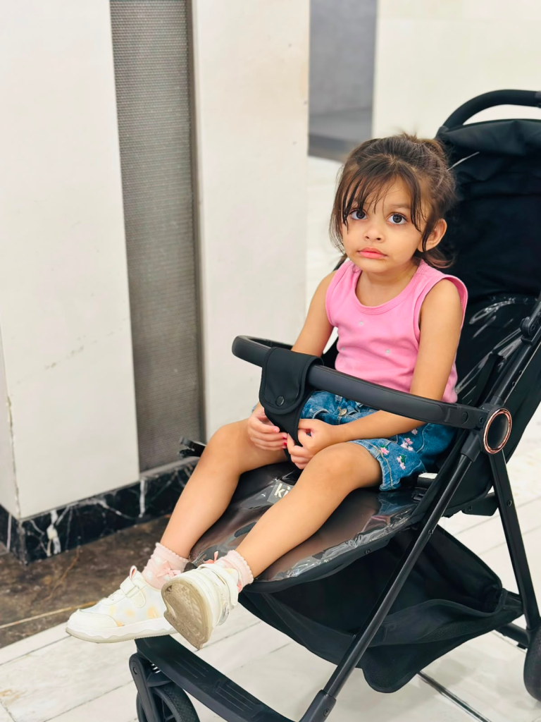 Fatima sitting in a stroller