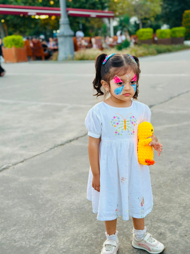 zainab with colorful butterfly face paint during a shopping mall activity in Baku, Azerbaijan